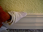 Use a damp, soft rag to smooth the caulking.