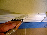 Cutting in base board to a wall.