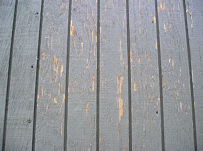 Peeling exterior paint on T111 wood siding.
