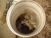 Used wood stain rags in bucket of water.