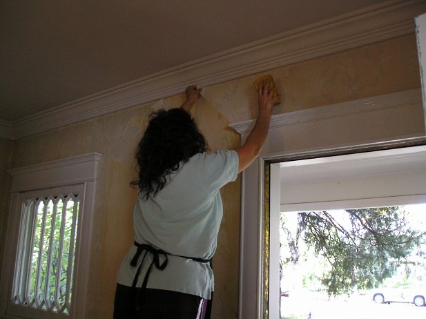 Cleaning wallpaper glue with sponge and water.