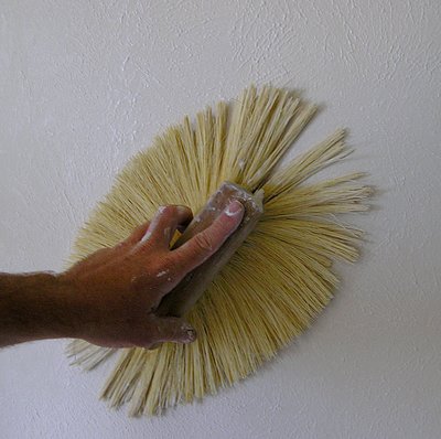Using a drywall texture brush.