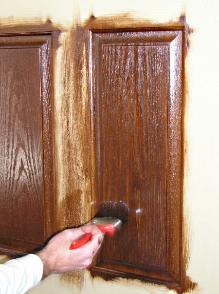 Finishing staining a fiberglass door raised panel.