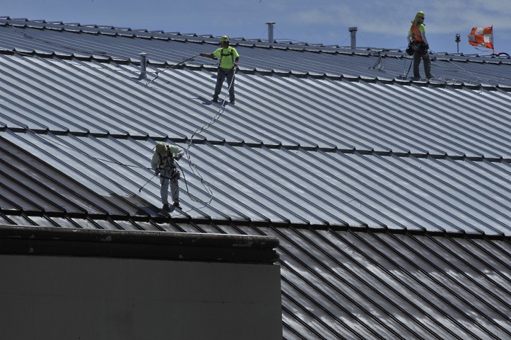 Applying a Roof Coating to Metal Roofing Panels.